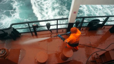 Gudmoder Halldorsson hoses down the deck of the Bruarfoss as it sails from Newfoundland to Iceland.