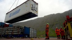 The crew of the Bruarfoss loads a refrigerated container packed with frozen fish. The Bruarfoss is in Isafjordur, a small port on the northwest coast of Iceland.